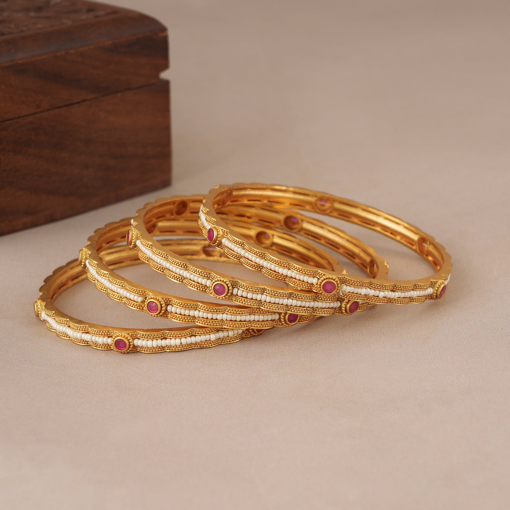 Elegant gold plated pearl bangle set (set of 4)