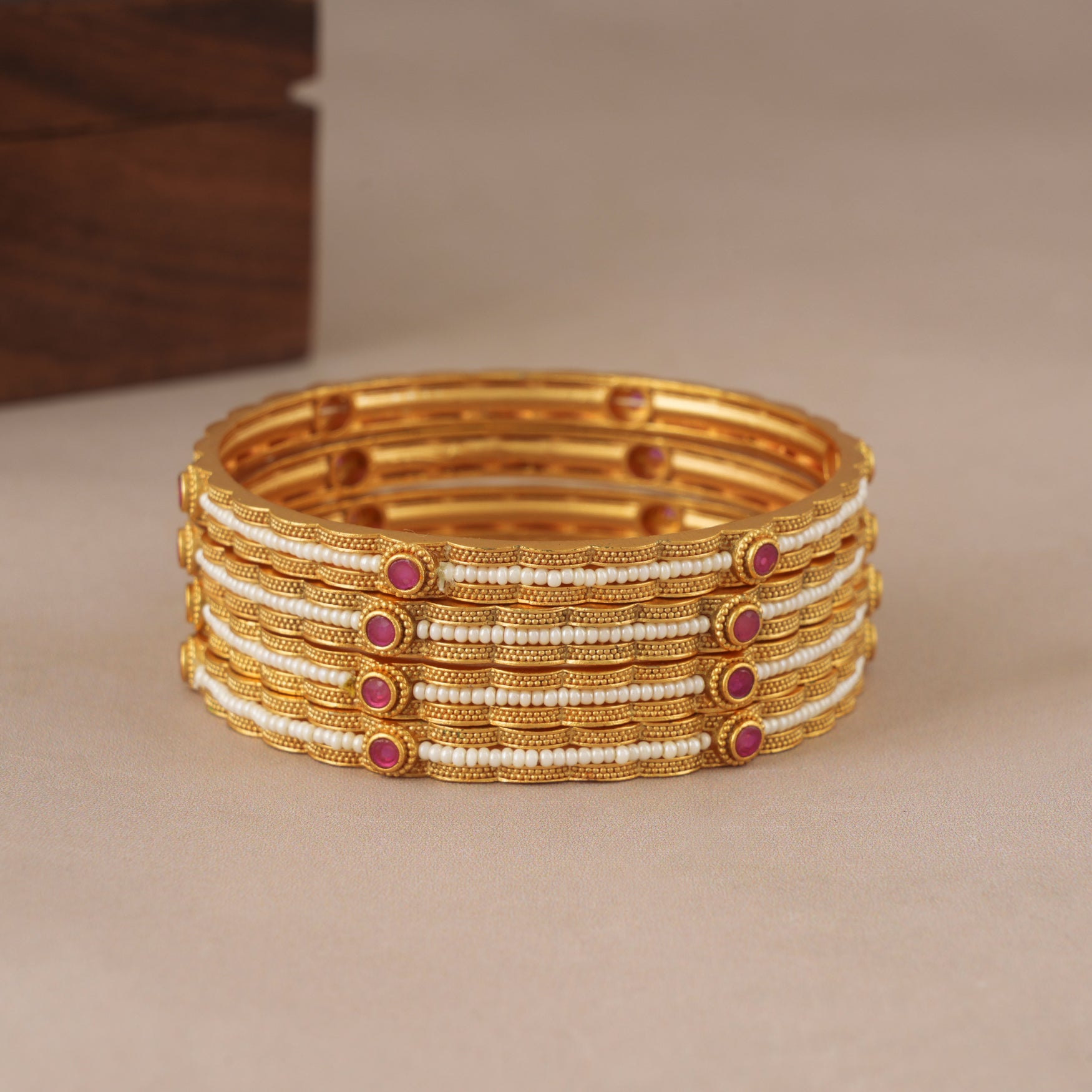 Elegant gold plated pearl bangle set (set of 4)