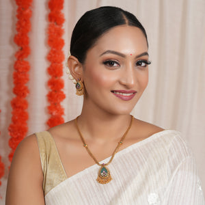 Long antique gold emerald stone pendant set