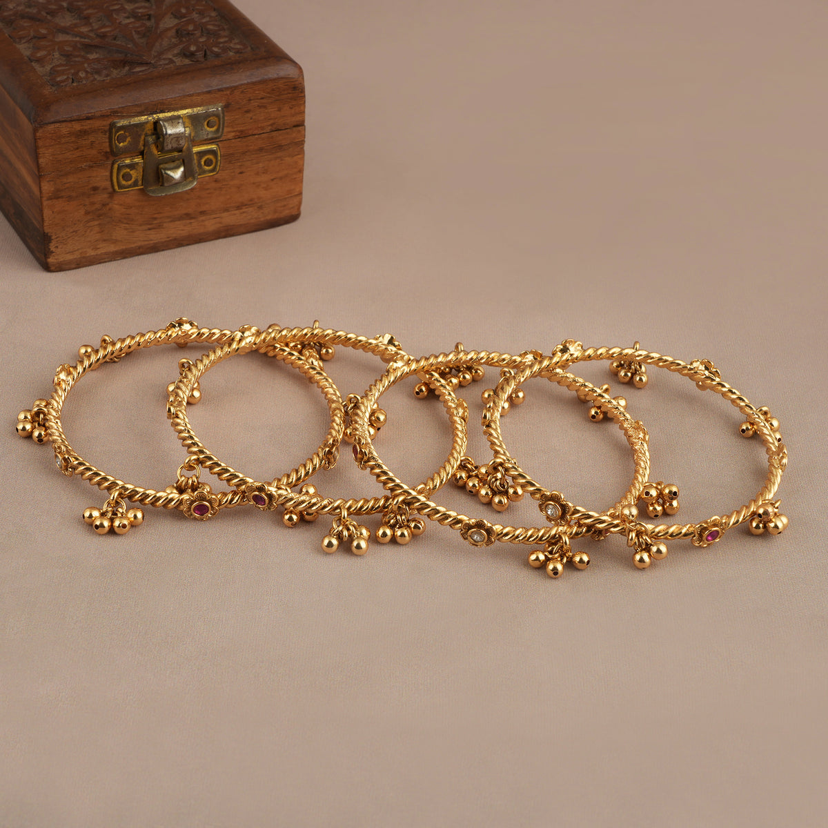 Beautiful antique gold stone ghungroo bangle set ( set of 4 )