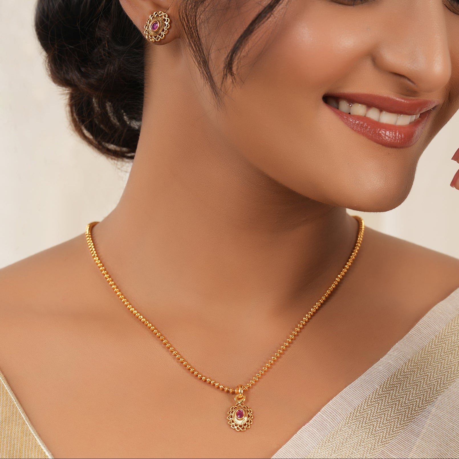 Cute oval ruby gold plated pendant set