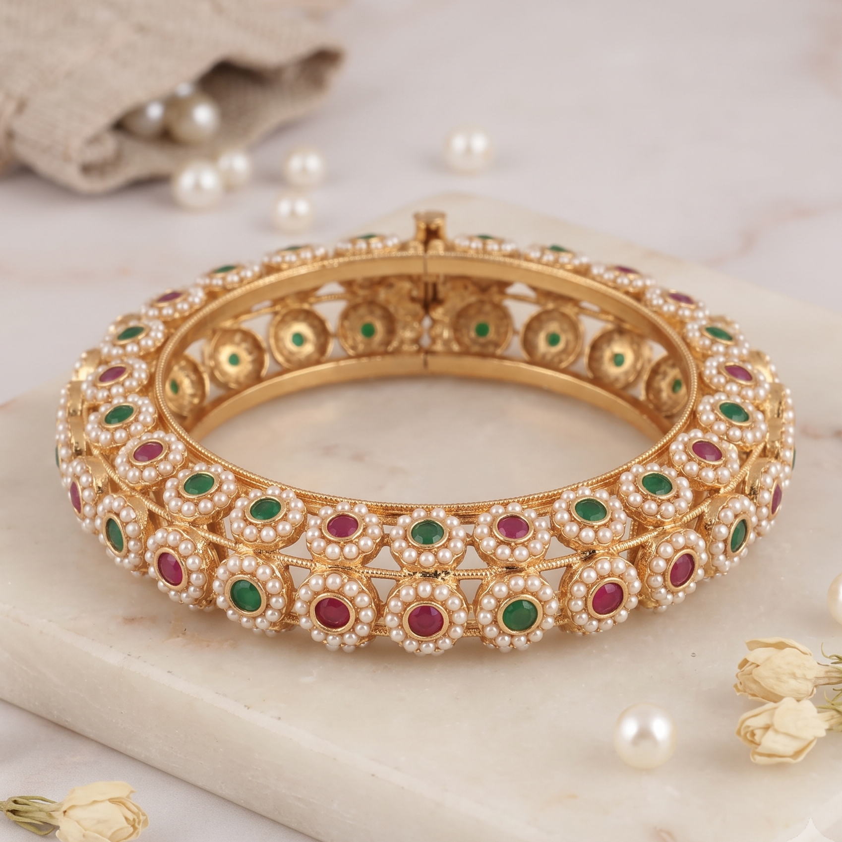 Beautiful gold finish pearl studded stone kada